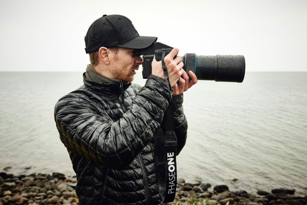 Photographer capturing a race car on the track