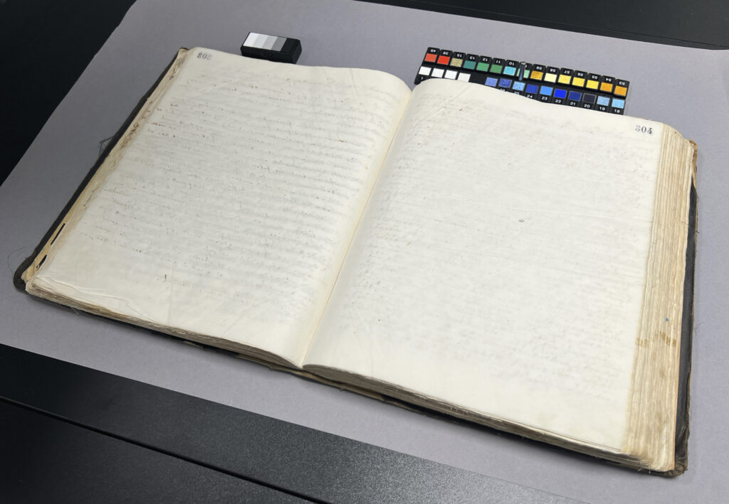The protocol Copybook for Aalesunds Stadsingeniørkontor 1903 – 04 showing one of the faded pages, with a selection of patches using multispectral imaging technology. Photo credit: Ottar A.B Anderson