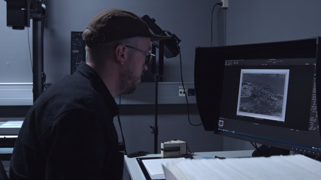 Library technician operating high-end digitization camera